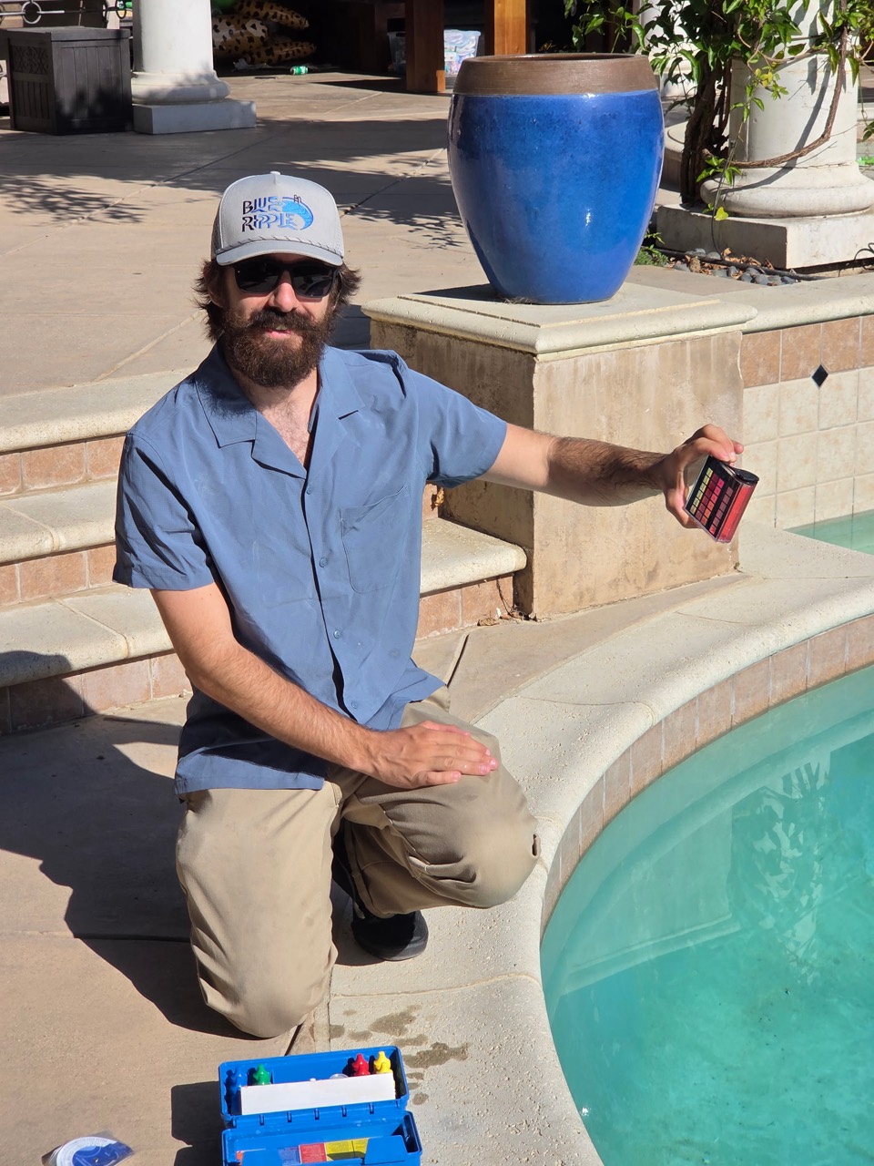 Blue Ripple Pool Care technician testing pool water chemistry